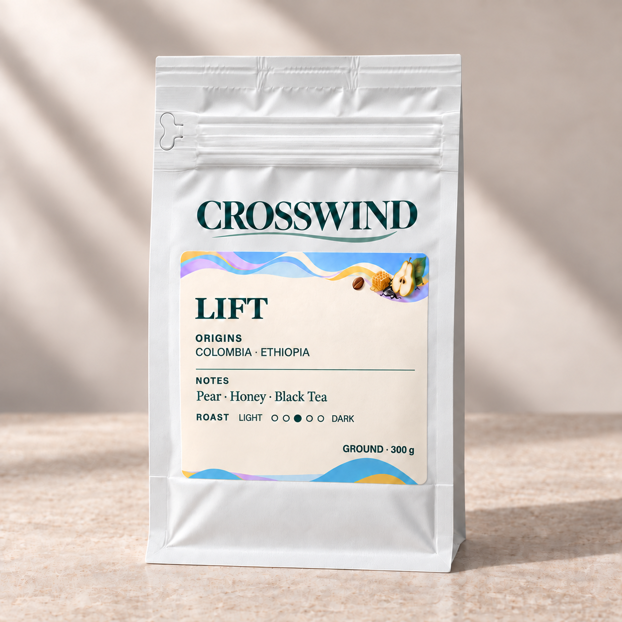 Crosswind Lift 300 g ground coffee in a sealed matte white pouch, labelled GROUND, with front zipper and left pull tab